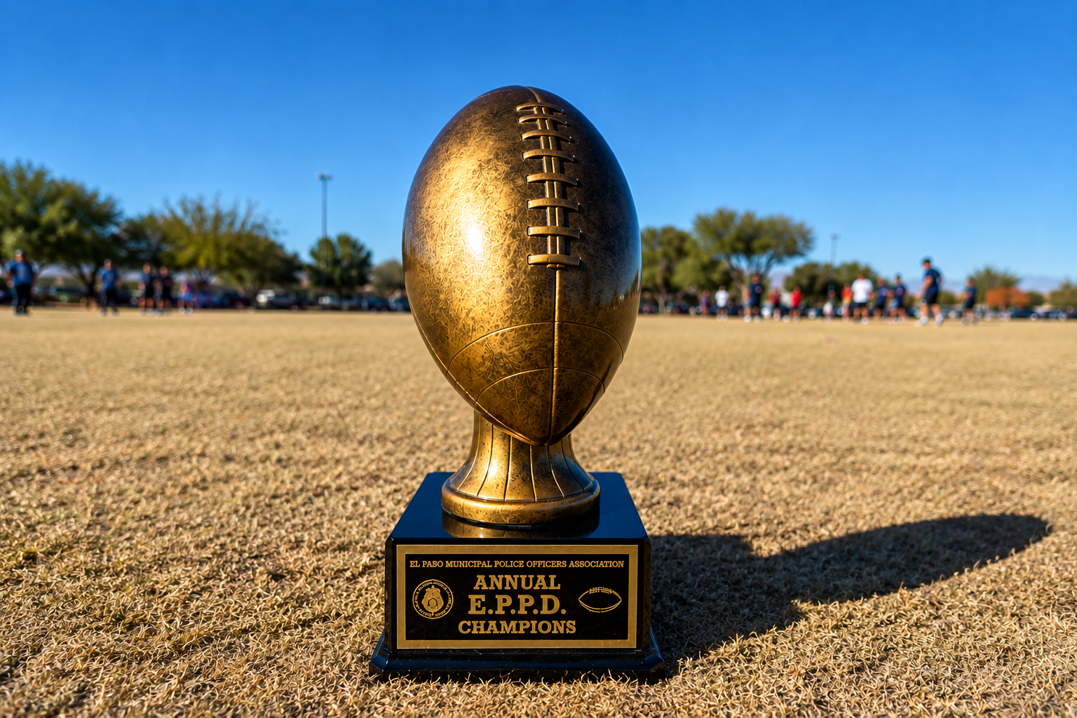 The EPMPOA Annual E.P.P.D. Champions football trophy on a field